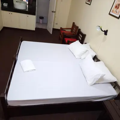 a bed with white sheets and pillows in a room at Cool Martin Family Hotel and Resort in Bacoor