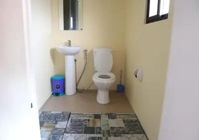 a bathroom with a toilet and a sink at Cool Martin Family Hotel and Resort in Bacoor