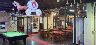 a restaurant with a ping pong table and a pool table at Cool Martin Family Hotel and Resort in Bacoor