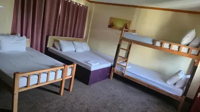 a bedroom with two bunk beds and a ladder at Cool Martin Family Hotel and Resort in Bacoor
