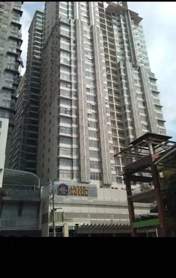 a large building with a sign in front of it at Luxury 2BR Condo in Makati Near Malls & Offices in Manila