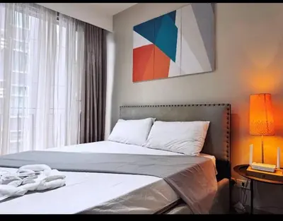 a bedroom with two beds next to a window at Luxury 2BR Condo in Makati Near Malls & Offices in Manila
