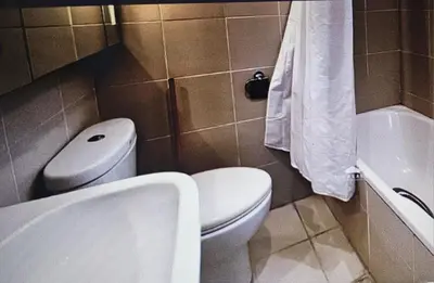 a bathroom with a toilet and a sink and a tub at Luxury 2BR Condo in Makati Near Malls & Offices in Manila