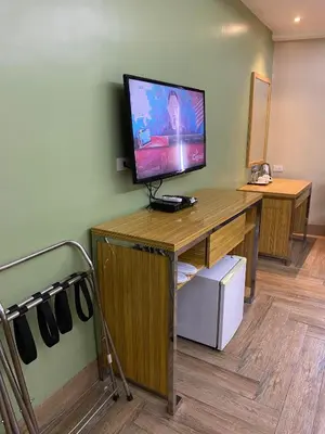 a room with a desk with a flat screen tv at Sun Star Grand Hotel in Manila
