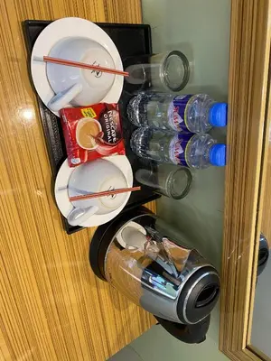 a bunch of plates and bottles in a refrigerator at Sun Star Grand Hotel in Manila