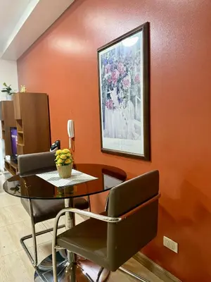 a office with a table and chairs in a room at The Gramercy Residences in Manila