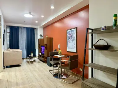 a living room with a table and a couch at The Gramercy Residences in Manila