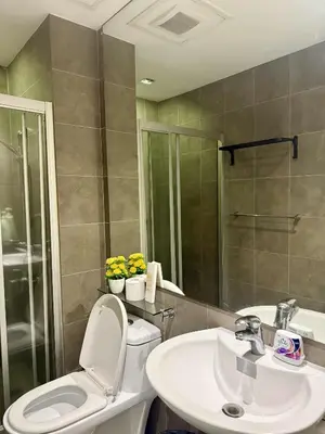 a bathroom with a toilet and a sink at The Gramercy Residences in Manila