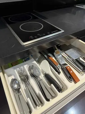 a drawer filled with utensils in a kitchen at The Gramercy Residences in Manila