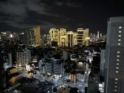 a view of a city at night with buildings at The Gramercy Residences in Manila