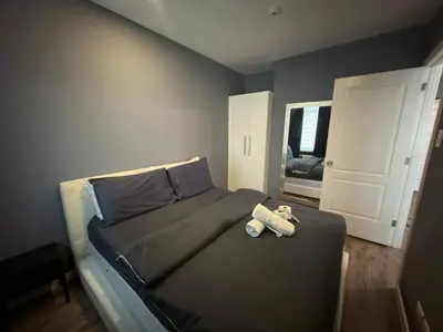 a bedroom with a bed with a teddy bear on it at The Gramercy Residences in Manila
