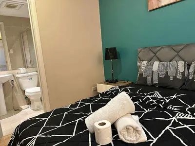 a bedroom with a bed with towels on it at The Gramercy Residences in Manila