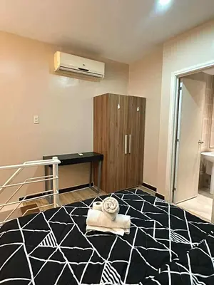 a room with a black and white patterned floor at The Gramercy Residences in Manila