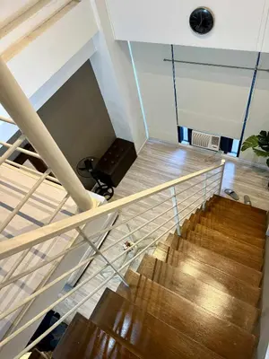 a spiral staircase in a room with wooden floors at The Gramercy Residences in Manila