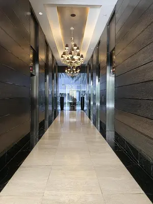 a hallway in a building with a chandelier at Stay in Makati 1-BR Condo with Pool, Fast WiFi, Gym, Balcony in Manila