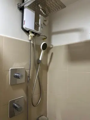 a shower in a bathroom with a shower head at Mall of Asia residence shore 3 in Manila