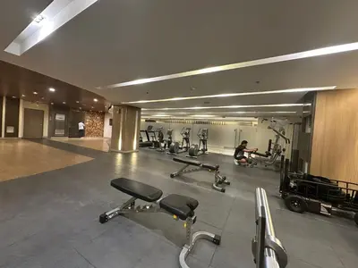 a gym with several exercise bikes and a person in the background at Mall of Asia residence shore 3 in Manila