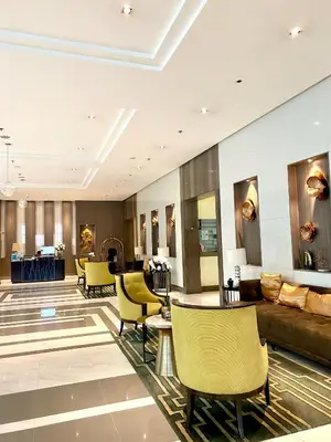 a lobby of a hotel with yellow chairs at Cluster 3, 81 Newport Blvd near NAIA T3 in Manila