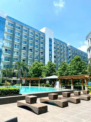 a large building with a swimming pool in front of a building at Cluster 3, 81 Newport Blvd near NAIA T3 in Manila