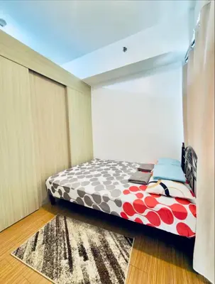 a bedroom with a bed and a rug at Room for Rent in Manila