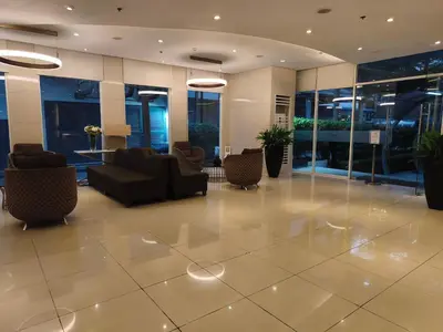 a lobby with couches and chairs in a building at Room for Rent in Manila