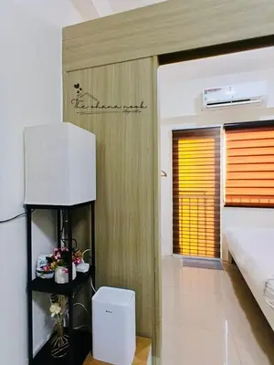 a room with a bed and a television in it at The Ohana Nook in Manila