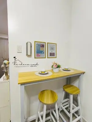 a kitchen with a counter with two yellow stools at The Ohana Nook in Manila