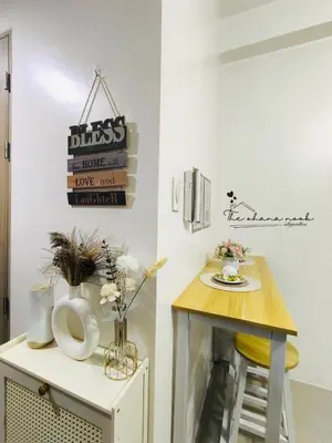 a room with a table and a small table with a stool at The Ohana Nook in Manila