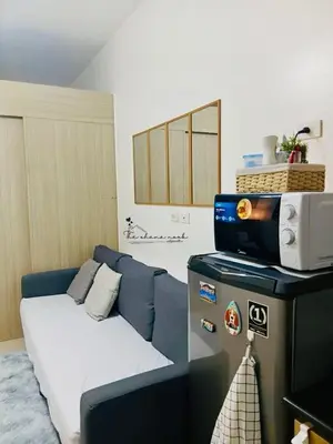 a living room with a couch and a tv at The Ohana Nook in Manila
