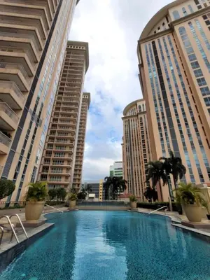 a swimming pool in the middle of two tall buildings at Urban Studio with Balcony in Manila