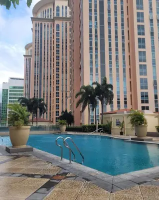 a swimming pool in front of some tall buildings at Urban Studio with Balcony in Manila