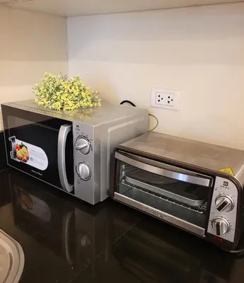 a toaster oven sitting on top of a counter at Urban Studio with Balcony in Manila