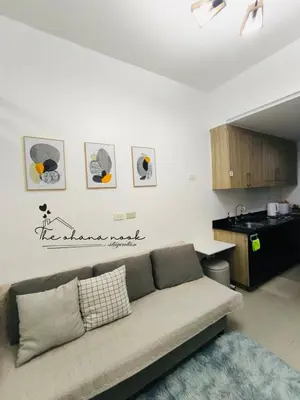 a living room with a couch and a kitchen at The Hearth Bliss in Manila