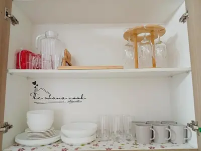 a shelf with plates and glassware on it at The Hearth Bliss in Manila