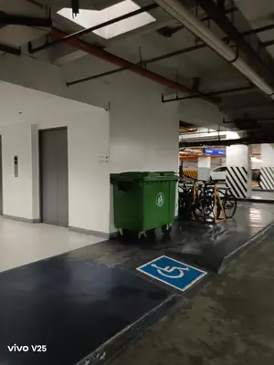 a parking lot with a green trash can and bicycles at Sea residences Sweetest escape in Manila