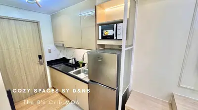 a kitchen with a stainless steel refrigerator with a microwave at SM MOA Near NAIA Airports The B's Crib MOA in Manila