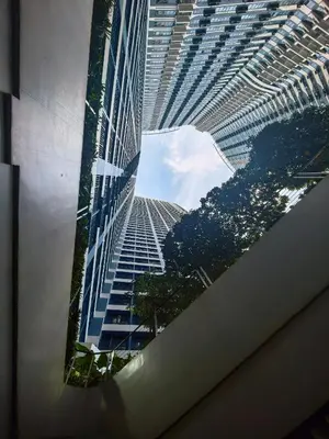 a view of a tall building from a window at Pine3s Turf in Manila