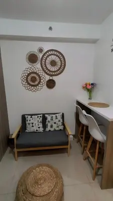 a living room with a couch and a table at EM's Staycation Walking distance to Mall of Asia in Manila