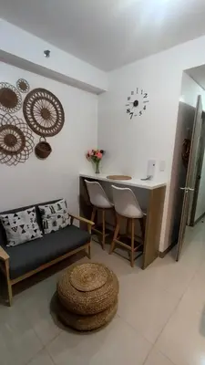 a living room with a table and a kitchen at EM's Staycation Walking distance to Mall of Asia in Manila