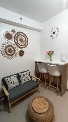 a living room with a couch and a table at EM's Staycation Walking distance to Mall of Asia in Manila