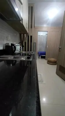 a kitchen with a black counter top in a room at EM's Staycation Walking distance to Mall of Asia in Manila