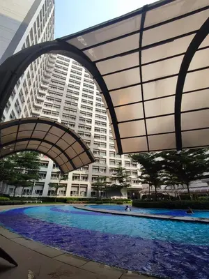 a large building with a swimming pool in front of it at SMDC Grace Residences Tower 4 in Manila