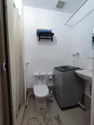 a small bathroom with a toilet and a sink at SMDC Grace Residences Tower 4 in Manila