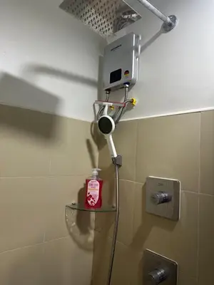 a bathroom with a hair dryer on the wall at Gateway Mall of asia Shore 3 in Manila