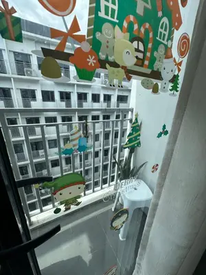 a window with stickers of a building on the wall at Gateway Mall of asia Shore 3 in Manila