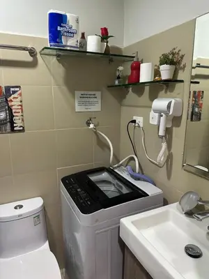 a small bathroom with a toilet and a sink at Gateway Mall of asia Shore 3 in Manila