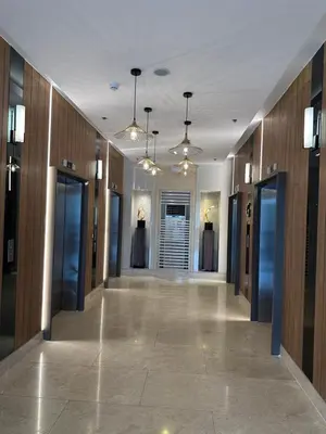 a hallway in a building with a row of doors at Gateway Mall of asia Shore 3 in Manila