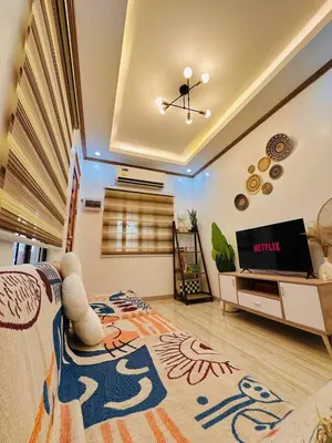 a living room with a couch and a tv at PPL Homestay