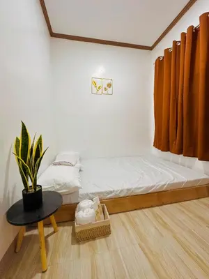a small bedroom with a bed and a table at PPL Homestay