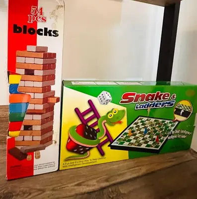 a box of lego blocks and a game on a shelf at PPL Homestay